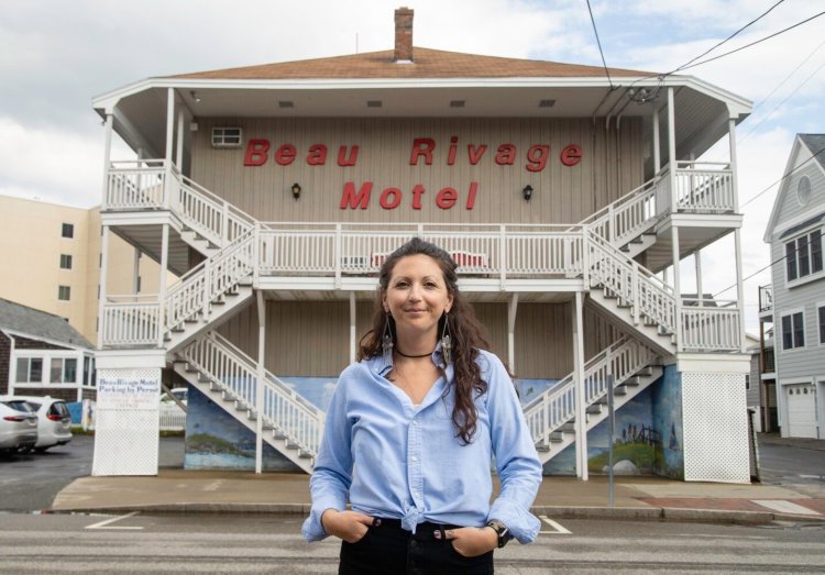 Beau Rivage Motel manager Sarah Alexander stands outside the Old Orchard Beach motel in July. In a typical year the motel hosts a mix of guests from both the U.S. and Canada, but for the past two summers, it, and others in the town, have missed out on Canadian tourists because the border remains closed for noncommercial travel.