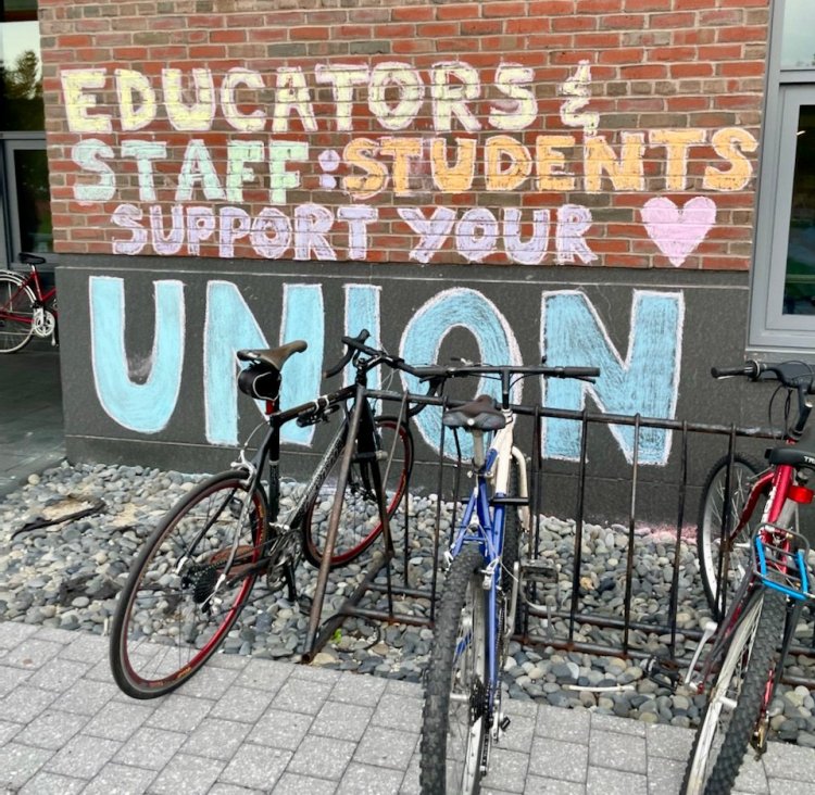 Students show support for staff unionization efforts Monday at Bates College in Lewiston, with chalk messages on Commons, the dining hall.