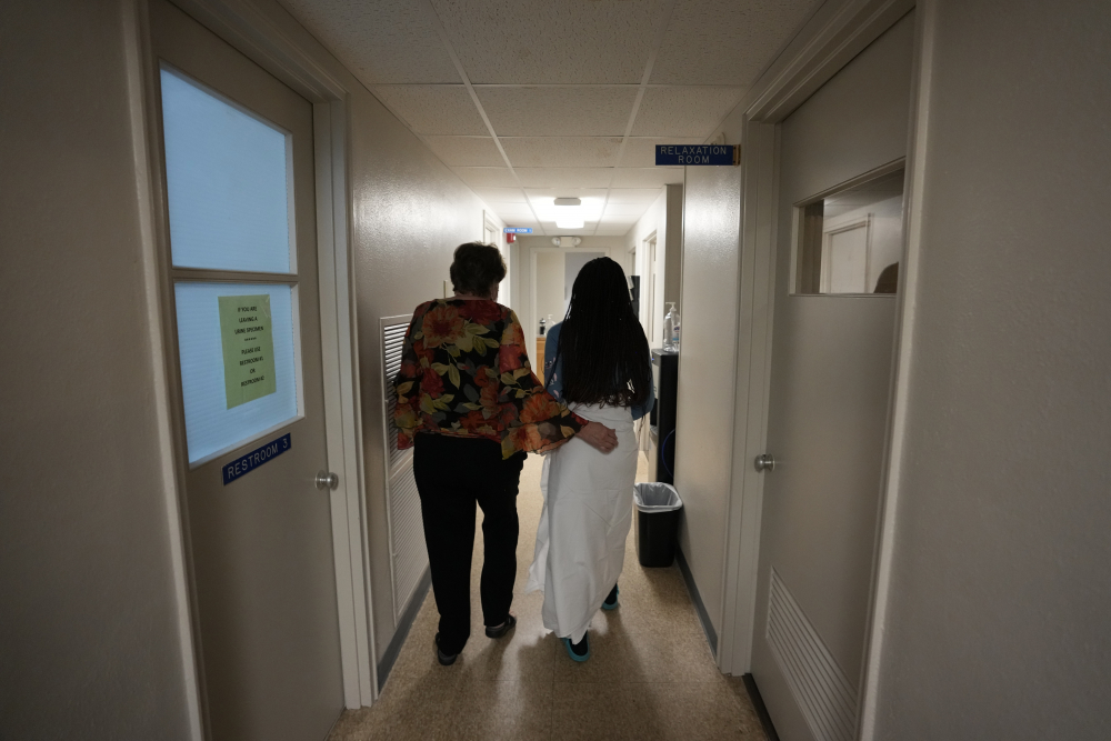 A 33-year-old mother of three from central Texas is escorted down the hall by clinic administrator Kathaleen Pittman before getting an abortion Saturday at Hope Medical Group for Women in Shreveport, La. 

