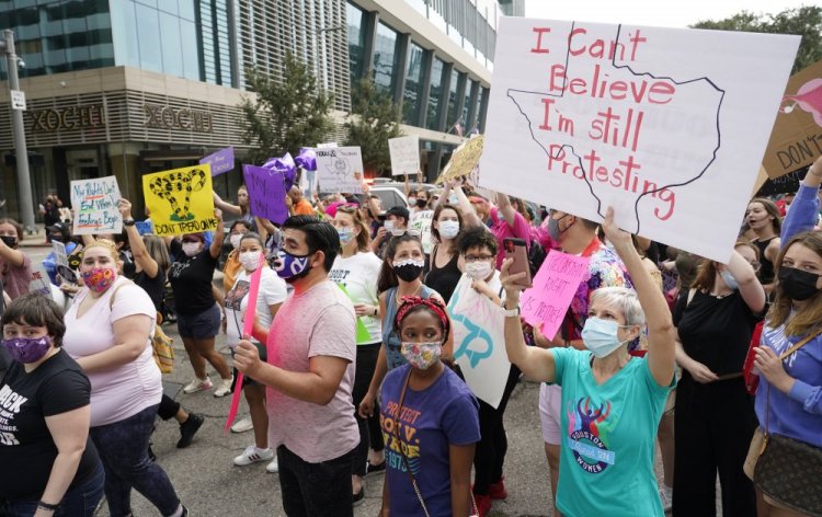 People participating in the Houston Women's March against the Texas abortion ban walk to City Hall on Oct. 2.  

