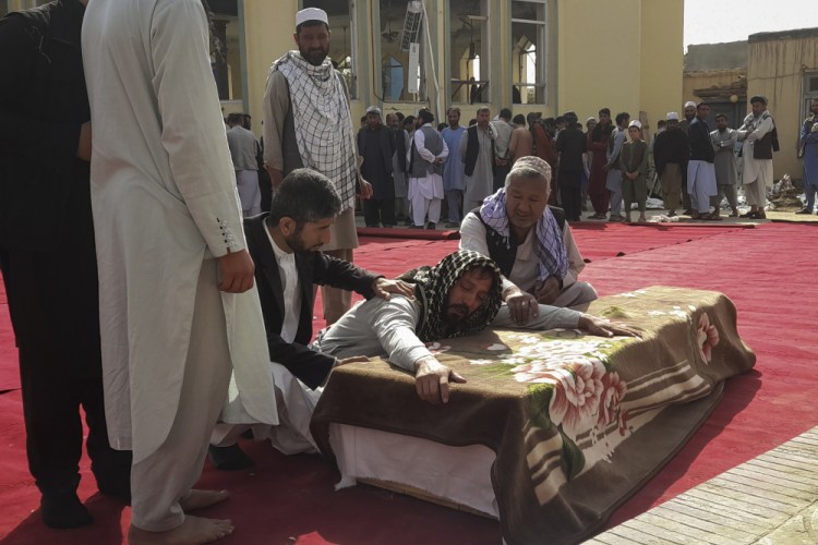 Relatives and residents attend a funeral for victims of a suicide attack at the Gozar-e-Sayed Abad Mosque in Kunduz, northern Afghanistan, on Saturday. The mosque was packed with Shiite Muslim worshippers when an Islamic State bomber attacked during Friday prayers, killing dozens in the latest security challenge to the Taliban as they transition from insurgency to governance. 