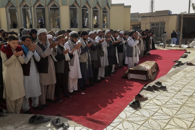 Relatives and residents pray during a funeral ceremony for victims of a suicide attack at the Gozar-e-Sayed Abad Mosque in Kunduz, northern Afghanistan, on Saturday. The Islamic State claimed responsibility for the bombing, which killed 46 worshippers.
