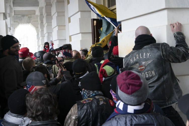 Insurrectionists loyal to Donald Trump try to open a door of the U.S. Capitol as they riot in Washington on Jan. 6. 