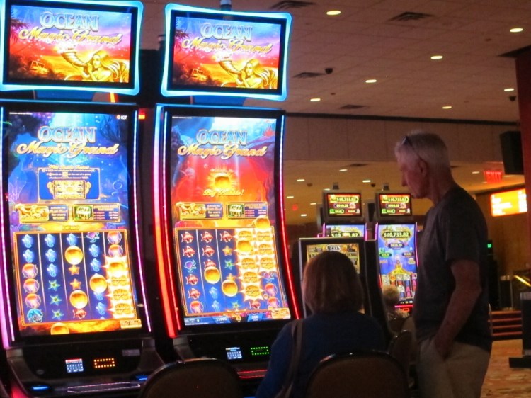 People play slot machines June 23 at Bally's casino in Atlantic City, N.J. 

