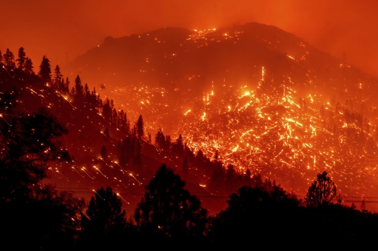 Embers light up hillsides as the Dixie Fire burns near Milford in Lassen County, Calif., in August. World leaders have been trying to do something about climate change for 29 years but in that time Earth has gotten much hotter and more dangerous. (AP Photo/Noah Berger, File)