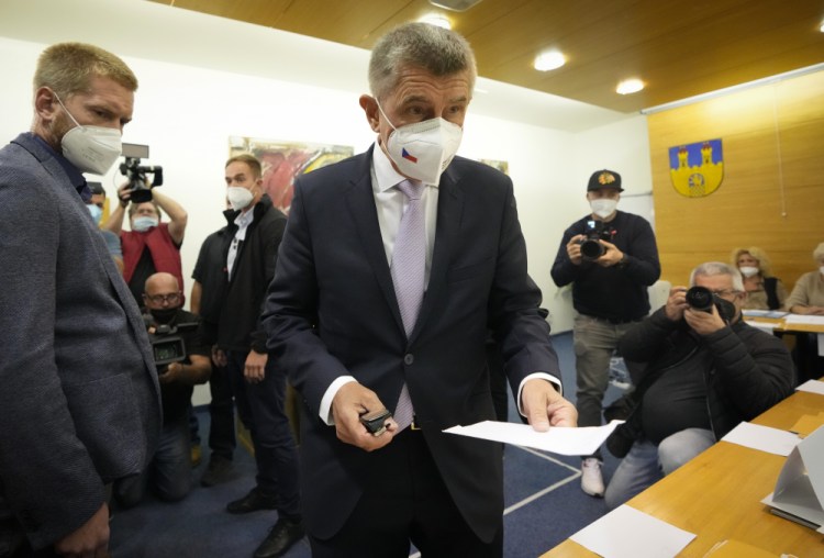 Czech Republic's Prime Minister and leader of centrist ANO (YES) movement Andrej Babis holds his ballot at a polling station in Lovosice, Czech Republic, Friday, Oct. 8, 2021. Czechs begin voting in a parliamentary election with polls showing Prime Minister Andrej Babis, a populist billionaire, has a good chance of keeping his job, despite a new scandal over his financial dealings. (AP Photo/Petr David Josek)