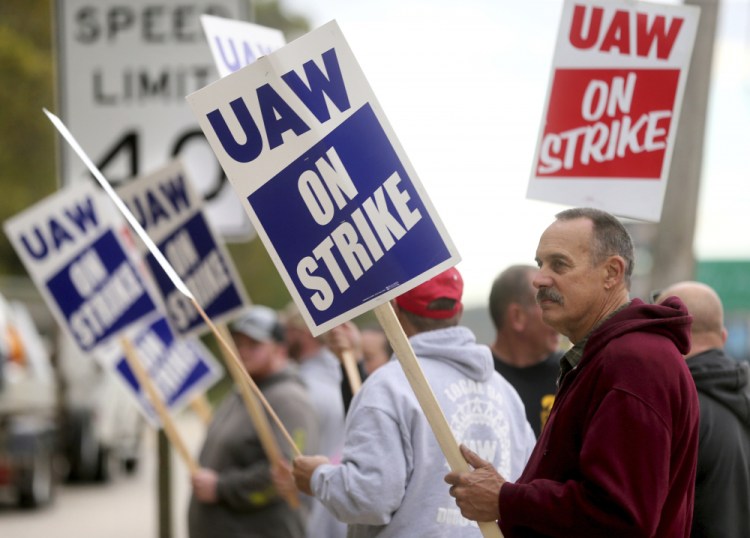 John Deere Dubuque Works union employee Steve Thor pickets outside UAW Local 94 in Dubuque, Iowa, on Thursday. More than 10,000 Deere & Co. workers went on strike Thursday, the first major walkout at the agricultural machinery giant in more than three decades. 