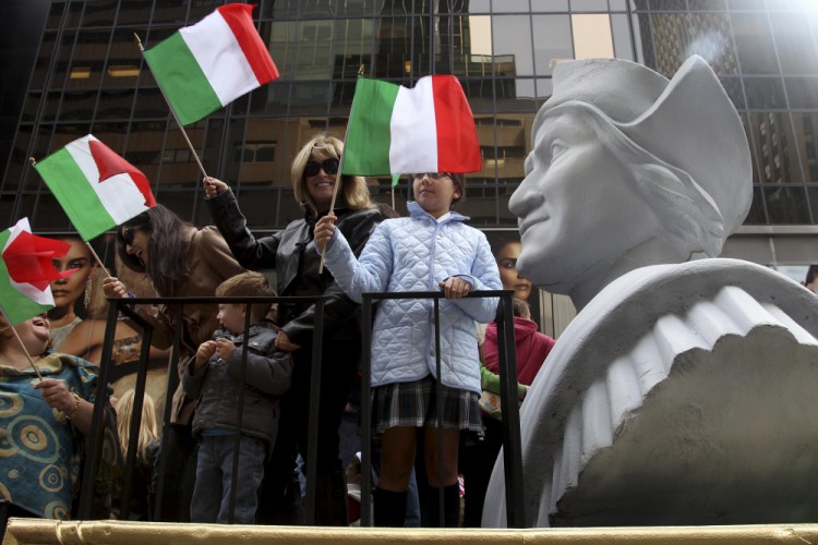 People ride on a float with a large bust of Christopher Columbus during the Columbus Day parade in 2012 in New York. 

