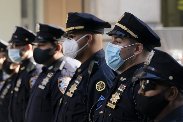 New York Police Department officers in masks stand during a service at St. Patrick's Cathedral in New York on Oct. 5 to honor 46 colleagues who have died due to COVID-19 related illness. 
