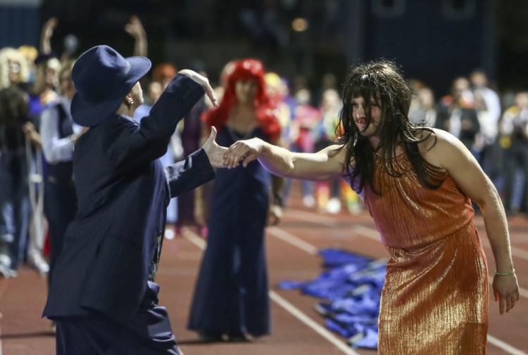People participate in the “drag ball" halftime show at Burlington High School on Friday night in Burlington, Vt. The event was part of that school's homecoming and was sponsored by the Gender Sexuality Alliance from Burlington and South Burlington high schools.  The football game was between a team made up of students from three Burlington-area schools Burlington, South Burlington and Winooski High Schools who played against St. Johnsbury Academy. 