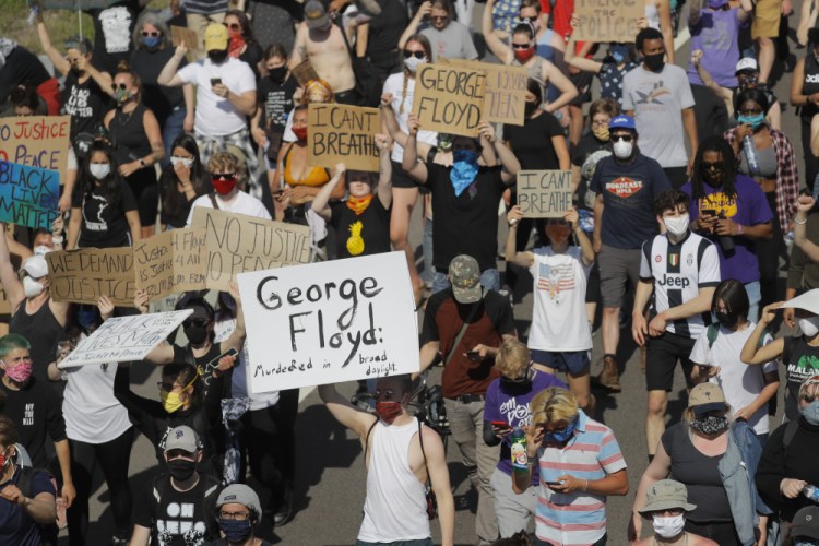 Demonstrators march in Minneapolis on May 31, 2020, as protests continued following the death of George Floyd, who died after being restrained by Minneapolis police officers.