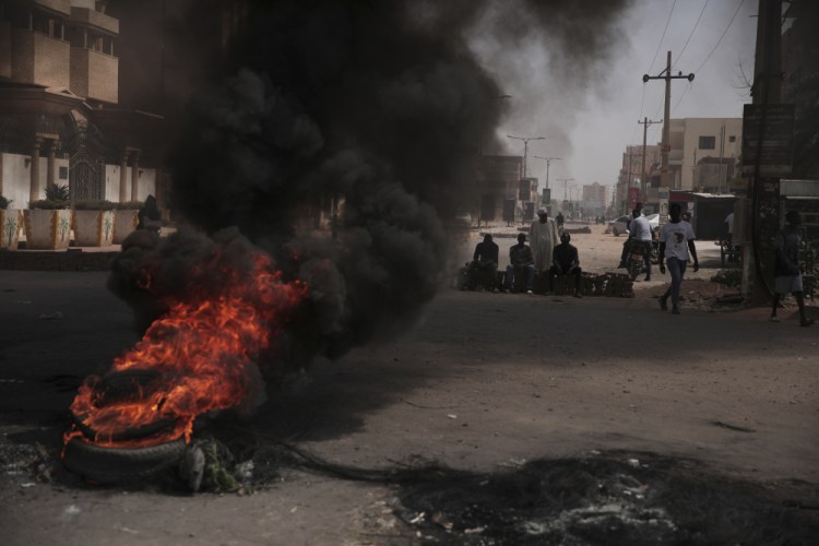 People burn tires during a protest a day after the military seized power Khartoum, Sudan, on Tuesday. The takeover came after weeks of mounting tensions between military and civilian leaders over the course and the pace of Sudan's transition to democracy.