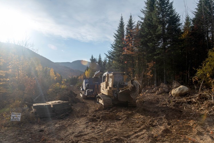 Construction equipment sits on a newly cut swath of forest for the New England Clean Energy Connect corridor near mile 16 on Spencer Road in the unorganized territories near Jackman on Oct. 12.