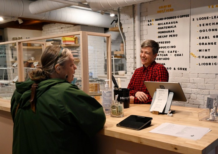 Anna Brown, co-owner of the Jackrabbit Cafe, speaks with Leslie Allen of Kennebunk during Allen's visit to the cafe Friday. Brown said "it felt like a punch in the gut" to hear about potential rent increases under new owners of the Pepperell Mill Campus.