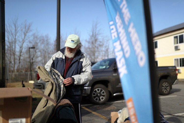 Reggie Humphrey, 65, looks through donations of clothing to homeless people living at Days Inn in South Portland. As the challenges of homeless populations grow, some believe South Portland’s hotels will continue to house shelter clients for the foreseeable future.