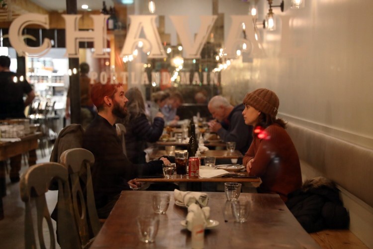 Will and Nicole Corke, of Camden, dine at Chaval restaurant in Portland on Tuesday. Maine's restaurants and hotels had record-breaking sales this summer, but faced high labor costs and other challenges.