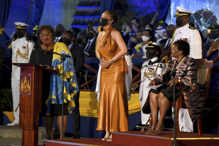 Barbados' Prime Minister Mia Mottley, left, and President of Barbados, Dame Sandra Mason, right, honor Rihanna on Tuesday in Bridgetown, Barbados. Barbados has stopped pledging allegiance to Queen Elizabeth II as it shed another vestige of its colonial past and became a republic for the first time in history. 