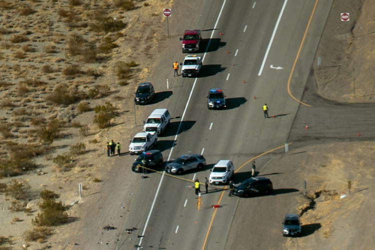 Nevada Highway Patrol investigate the scene of a fatal crash Dec. 10 involving bicyclists and a box truck along Highway 95 near Searchlight, Nev. 