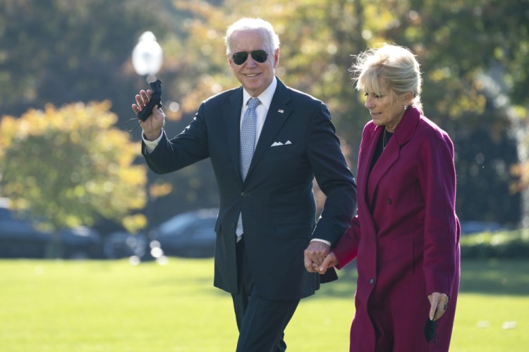 President Joe Biden and first lady Jill Biden arrive on the South Lawn of the White House after spending the weekend in Rehoboth Beach, Del., Monday, Nov. 8, in Washington. 