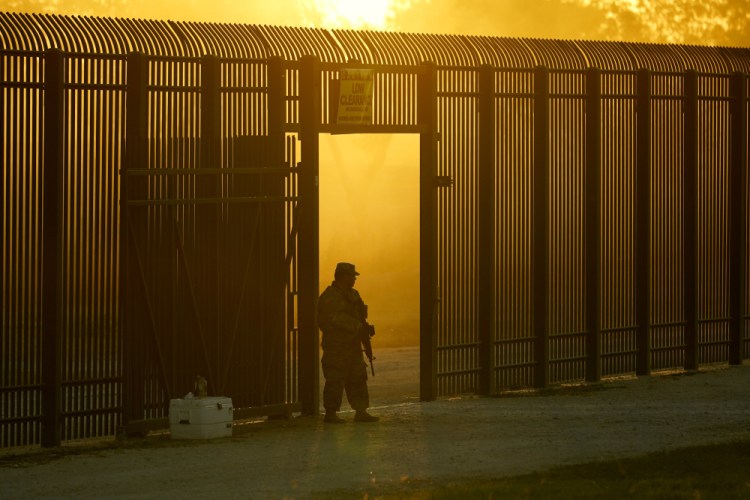 A National Guardsman stands guard at a fence that runs along the Rio Grande near the International bridge Sept. 17 in Del Rio, Texas.