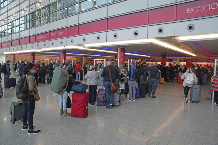 Passengers queue at London Heathrow Airport's T3 as the US reopens its borders to UK visitors in a significant boost to the travel sector, in London, Monday, Nov. 8. 