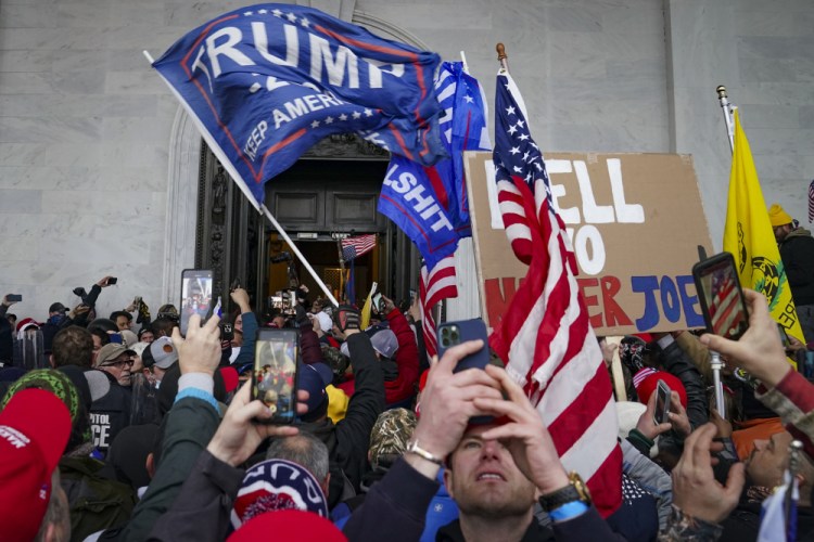 Insurrections loyal to President Donald Trump riot outside the Capitol in Washington on Jan. 6. 