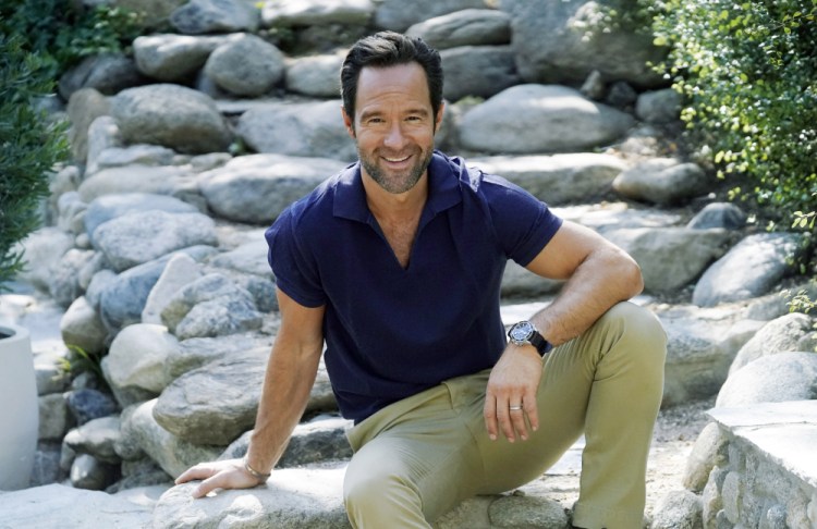 Actor and voiceover artist Chris Diamantopoulos poses at his home in Los Angeles. Diamantopoulos stars in the Netflix film "Red Notice." (AP Photo/Chris Pizzello)