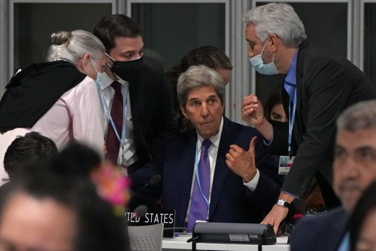 John Kerry, U.S. special presidential envoy for climate, center, confers during a stock-taking plenary session at the COP26 U.N. Climate Summit in Glasgow, Scotland, on Saturday. 