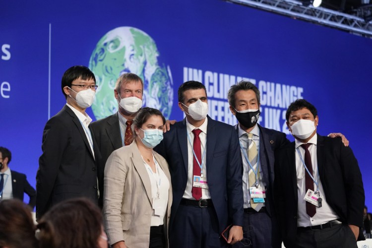 Delegates from countries, including Egypt, Japan and Singapore, on stage at the COP26 U.N. Climate Summit, in Glasgow, Scotland, on Saturday.
