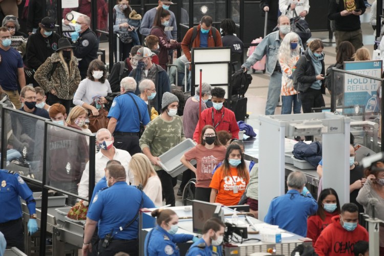 Travelers line up at the south security checkpoint as traffic increases with the Thanksgiving holiday on Tuesday at Denver International Airport in Denver. 