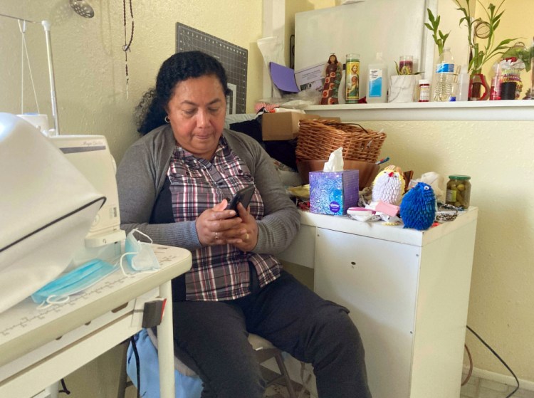 Rosalidia Dardon, 54, looks at a picture of her daughter in El Salvador as she sits in a refugee house in Texas, awaiting asylum or a protected immigration status on Nov. 4. Dardon knows from personal experience why the language surrounding immigration is so important.