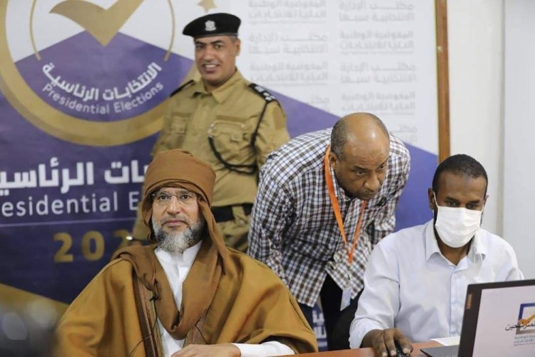 Seif al-Islam, left, the son and one-time heir apparent of late Libyan dictator Moammar Gadhafi registers his candidacy for the country’s presidential elections next month, in Sabha, Libya, on Sunday.

