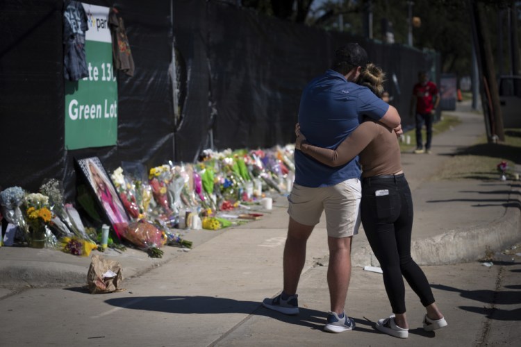 Two people who knew a victim of the fatal incident at the Houston Astroworld concert embrace at a memorial on Sunday. 

