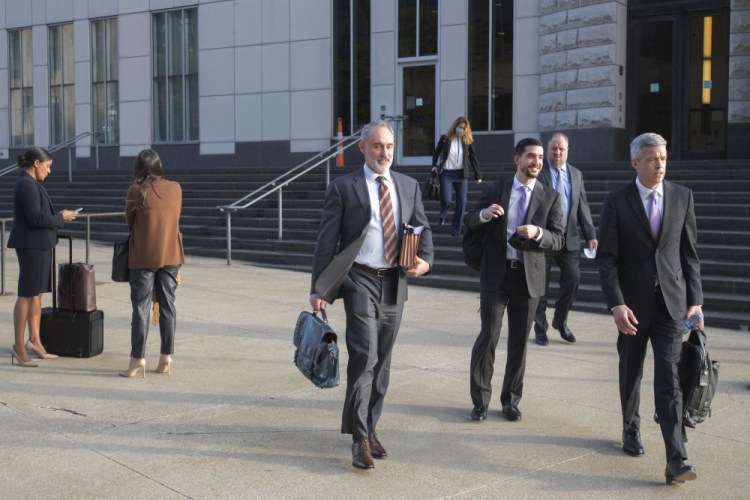 Attorneys and staff associated with a federal trial of pharmacy chains  leave the Carl B. Stokes Federal Courthouse in Cleveland on Monday. A federal jury on Tuesday found three retail pharmacy chains recklessly distributed massive amounts of pain pills in two Ohio counties. 