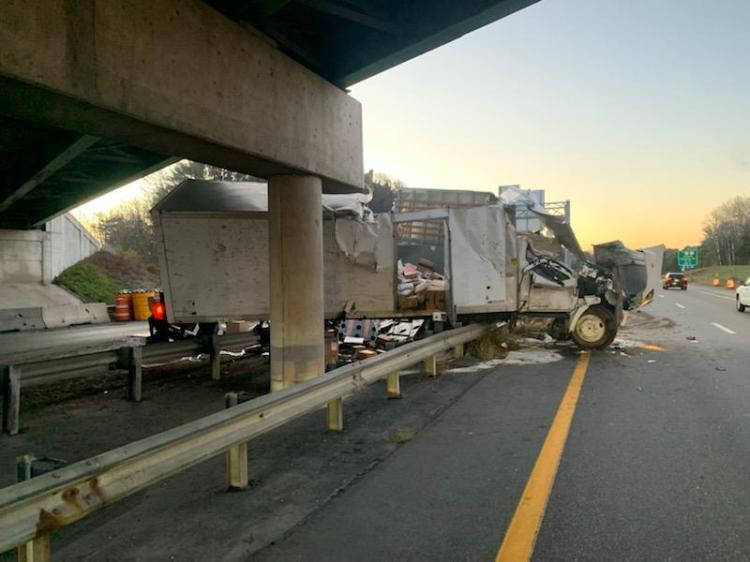 A box truck filled with packages crashed early Saturday morning on the Maine Turnpike in Portland, slowing traffic for several hours in both directions.