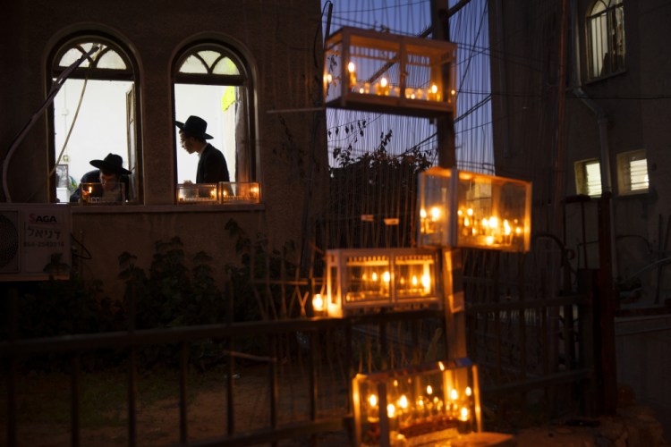 Ultra-Orthodox Jewish yeshiva students light candles on the first day of the Jewish holiday of Hanukkah in the ultra-Orthodox city of Bnei Brak near Tel Aviv, Israel in 2020. Hanukkah, also known as the Festival of Lights, is an eight-day commemoration of the Jewish uprising in the second century B.C. against the Greek-Syrian kingdom. 