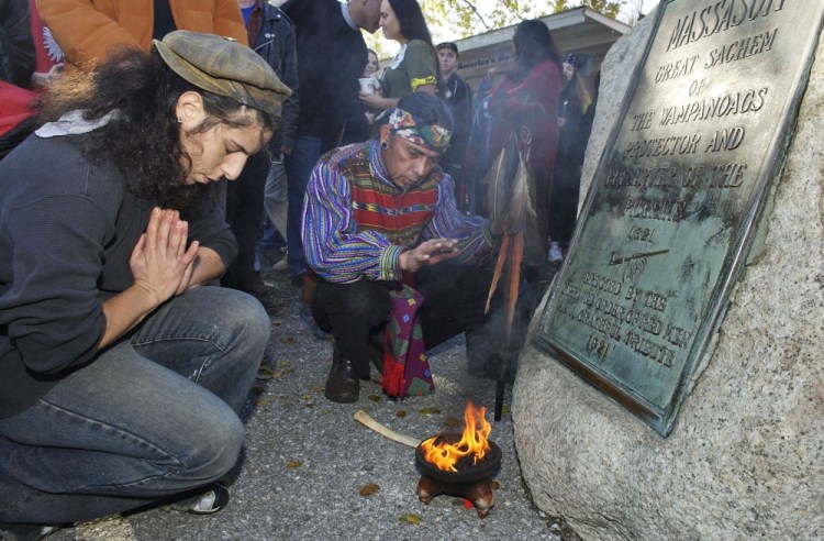 Supporters of Native Americans pause after a prayer during the 38th National Day of Mourning at Coles Hill in Plymouth, Mass., on Nov. 22, 2007. 
