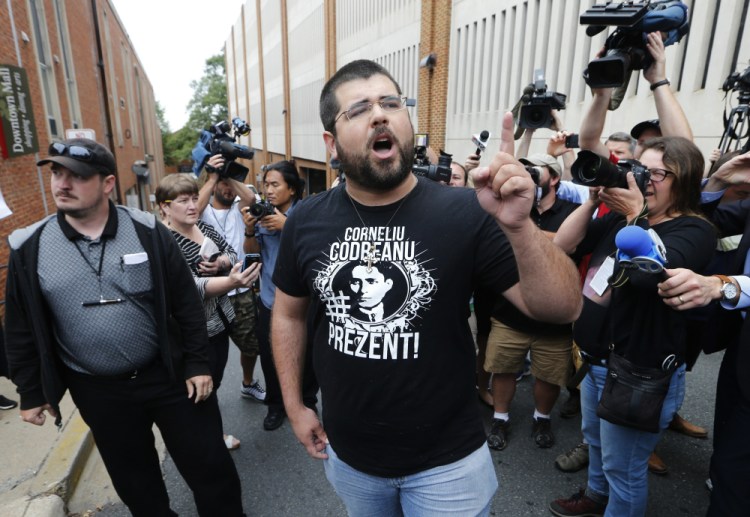 Matthew Heimbach voices his displeasure at the media in front of court in Charlottesville, Va., in 2017, after a court hearing for James Alex Fields Jr., who was accused of plowing his car into a crowd at a white nationalist rally. A Charlottesville jury found five white supremacist and neo-Nazi organizations and their leaders liable for millions of dollars in damages at a trial four years after violence rocked the Virginia city during the Unite the Right rally.