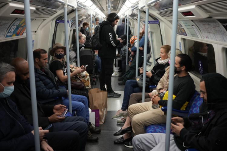 People travel on a London underground tube train on the Jubilee Line, where face coverings are required to be worn over people's mouths and noses, in London, Wednesday, Oct. 20. The World Health Organization said there was a 7% rise in new coronavirus cases across Europe last week, the only region in the world where cases increased. 