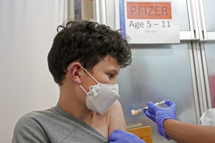 Leo Hahn, 11, gets the first shot of the Pfizer COVID-19 vaccine, Tuesday, Nov. 9, 2021, at the University of Washington Medical Center in Seattle. 