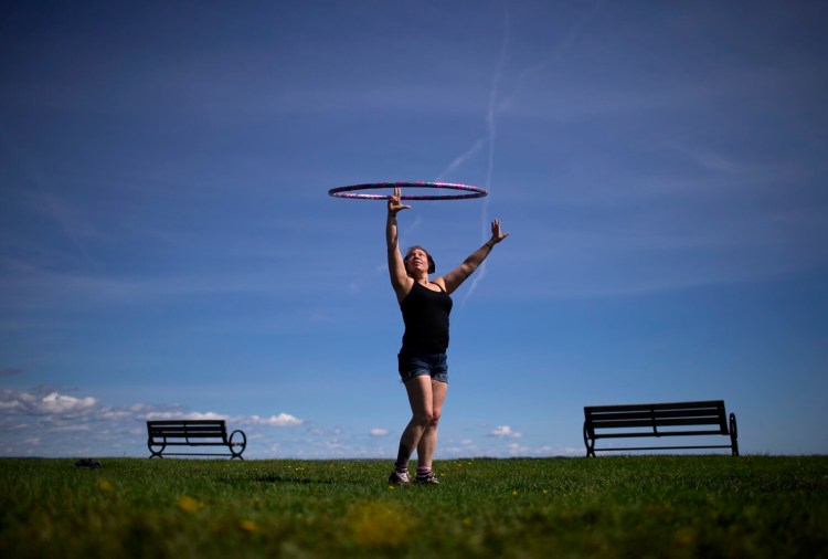  Abbey Schneider of Portland dances with a hula hoop at the Eastern Promenade in September. Maybe this is your year to learn some hooping skills.