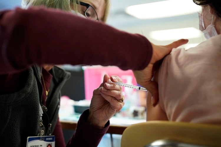 Debbie Breton, a nurse with Northern Light Health, administers a Pfizer vaccine to a sixth-grade student at Memorial Middle School during a clinic at the South Portland school in November. 