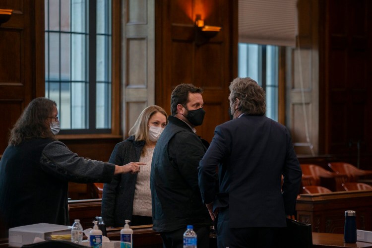 Shawn Purvis, center, speaks to his lawyer, Tom Hallett, following opening statements at his trial on Wednesday. 