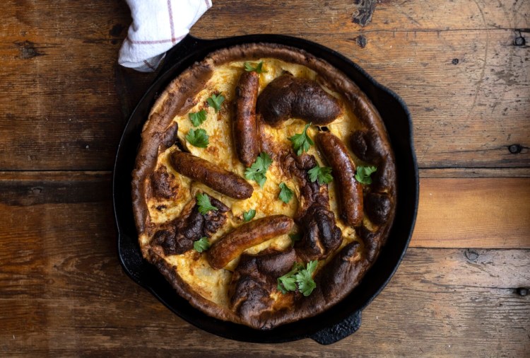 Toad-in-the-Hole, a classic British dish combining Yorkshire pudding and sausages. 