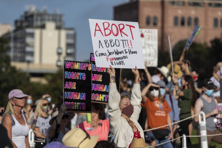 People attend the Women's March ATX rally on Oct. 2, at the Texas State Capitol in Austin, Texas.  At least 20 states, mostly across the South and Midwest, already have laws that would severely restrict or ban abortion if the Supreme Court overturns Roe v. Wade and leaves the issue up to the states.