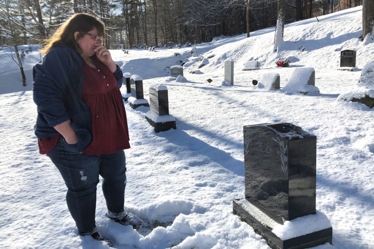 Deb Walker, of Chester, Vt., visits the grave of her daughter Brooke Goodwin, Thursday, Dec. 9, 2021, in Chester. Goodwin, 23, died in March of 2021 of a fatal overdose of the powerful opioid fentanyl and xylazine, an animal tranquilizer that is making its way into the illicit drug supply, particularly in the Northeast. (AP Photo/Lisa Rathke)
