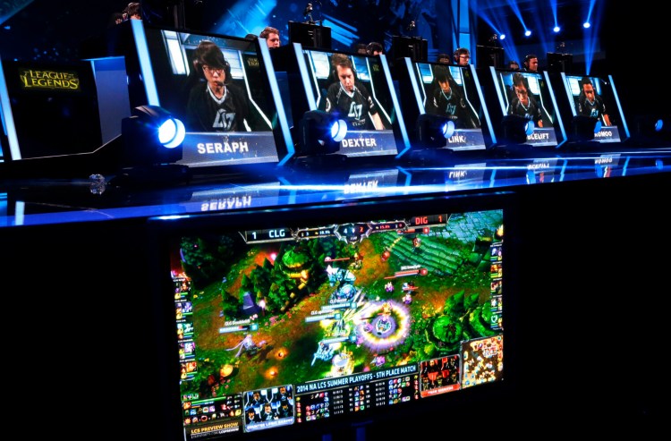 FILE - Competitors play in a "League of Legends" championship series video game competition at the Penny Arcade Expo, a fan-centric celebration of gaming, in Seattle on Aug. 29, 2014. On Tuesday, Dec. 28, 2021, Riot Games, the publisher behind the esports game, agreed to pay $100 million to settle a class-action lawsuit alleging pay disparity, gender discrimination and sexual harassment. (AP Photo/Ted S. Warren, File)