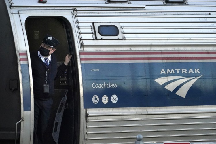 A conductor makes sure all is clear as the Amtrak Downeaster passenger train pulls out of the station on  Tuesday in Freeport. 