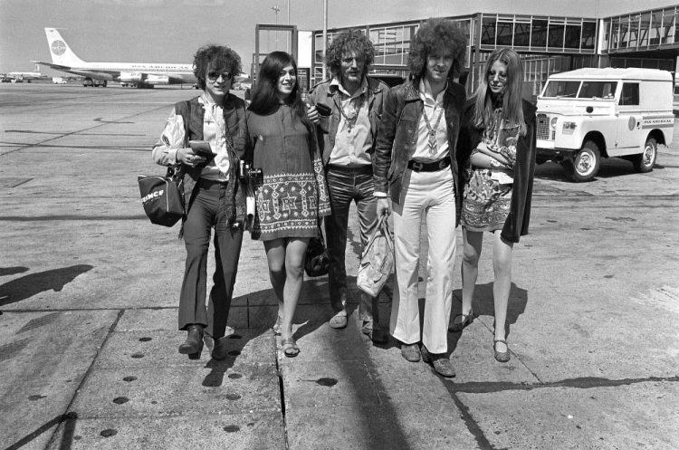 Members of the rock group Cream depart from Heathrow Airport in London in 1967 for their American tour. The trio, walking with unidentified female companions, from left are: bass guitarist Jack Bruce, drummer Ginger Baker and lead guitarist Eric Clapton. 