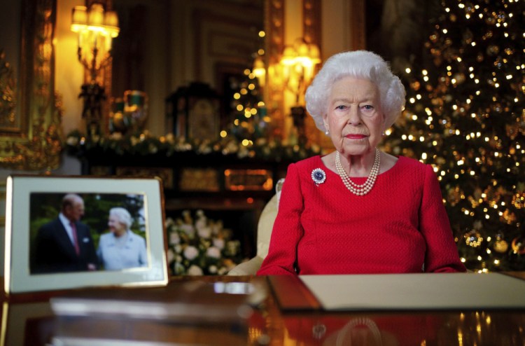 Britain's Queen Elizabeth II records her annual Christmas broadcast in Windsor Castle, Windsor, England. The photograph at left shows her and Prince Philip taken in 2007. 